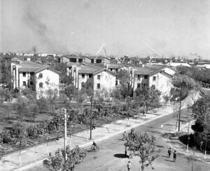 A black and white image of several 3-story houses