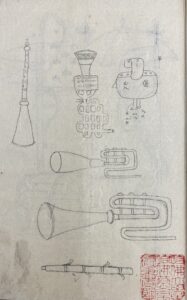 uncolored sketches of fantastical musical instruments and an ammunition bag