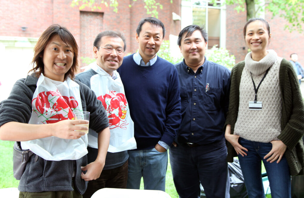 Prof. Chikamoto and four other scholars pose standing and smiling at the camera