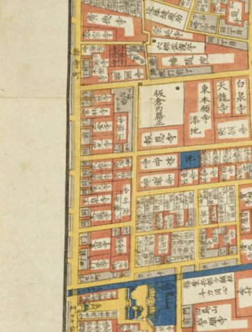 A map showing an overhead view of streets in yellow and buildings in pink and white, showing the Asakusa Shintera-machi 浅草新寺町