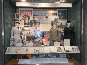 Various items such as coats and posters are displayed in a memorial for women in military service in the US